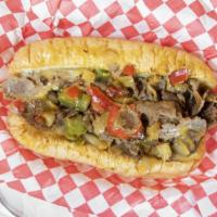 Philly Cheese Steak · Thin sliced rib eye steak cooked with sauteed green and red peppers, sauteed onions and ched...