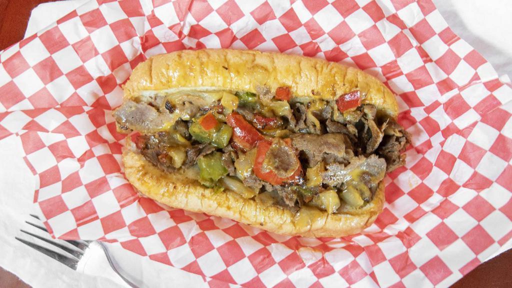Philly Cheese Steak · Thin sliced rib eye steak cooked with sauteed green and red peppers, sauteed onions and cheddar cheese sauce, served on an Amaroso roll.