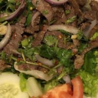 Larb · Spicy. Your choice of ground beef, pork, or chicken, cooked and mixed with lime juice, onion...