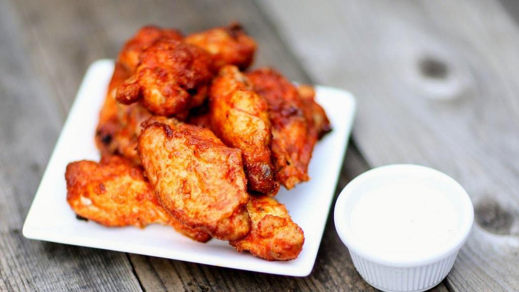 (5) Wings · Our bone-in wings are oven baked and coated in a flavorful tangy sauce.