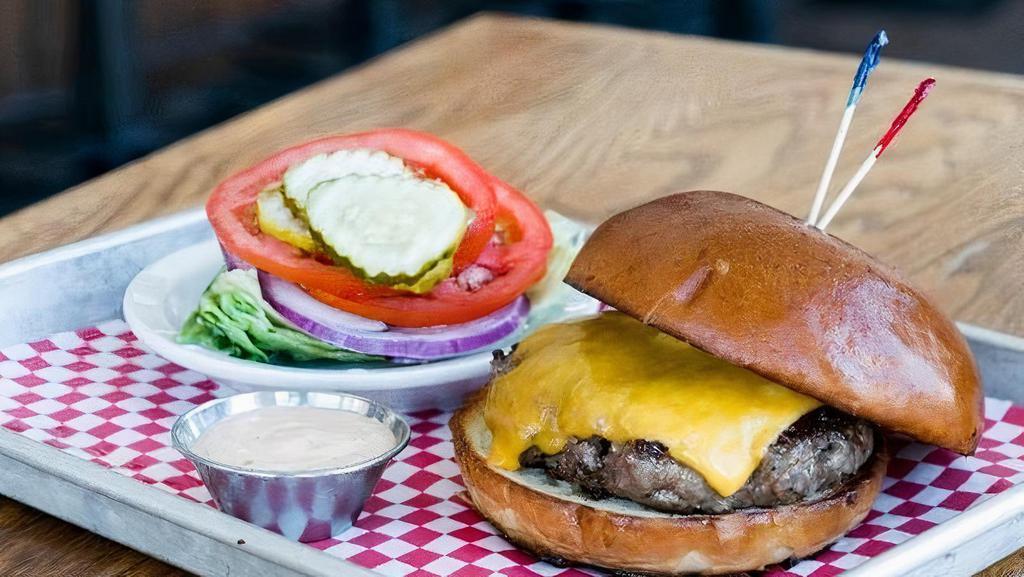 2/3 Lb Cheeseburger · 11 oz. house ground beef patty, cooked to choice of temperature & cheese. Served on a classic bun. *lettuce, tomato, onion & pickles served on the side*