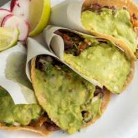 Taco · Mexican Street Taco on a Corn Tortilla, with Choice of Meat, Cilantro, Onion, Guacamole, and...