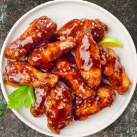 Smoking Bbq Chicken Wings · Fresh chicken wings fried until golden brown, and tossed in barbecue sauce. Served with a si...