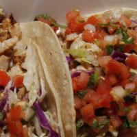 Fish Tacos · Grilled or breaded MahiMahi with cojita cheese, chipotle sauce, pico de gallo and cabbage on...