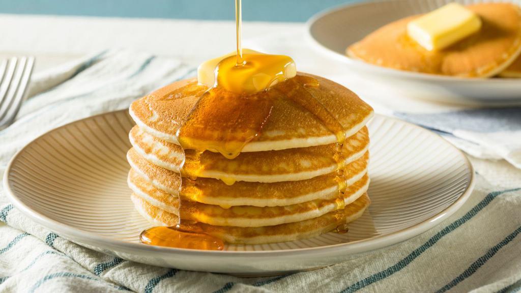 Short Stack Hotcakes · Fresh fluffy pancakes with a side of syrup and butter.
