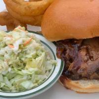 Bbq Beef · Thin sliced roast beef cooked with smokey bbq sauce on a fresh bun. Served with fries and co...