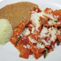Chilaquiles Rojos · A Mexican breakfast made of tortilla štrips, topped with red sauce melted cheese