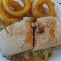 Exclusive · Sliced roasted beef with sautéed onion, peppers, and cheddar on a French roll.

Served raw o...