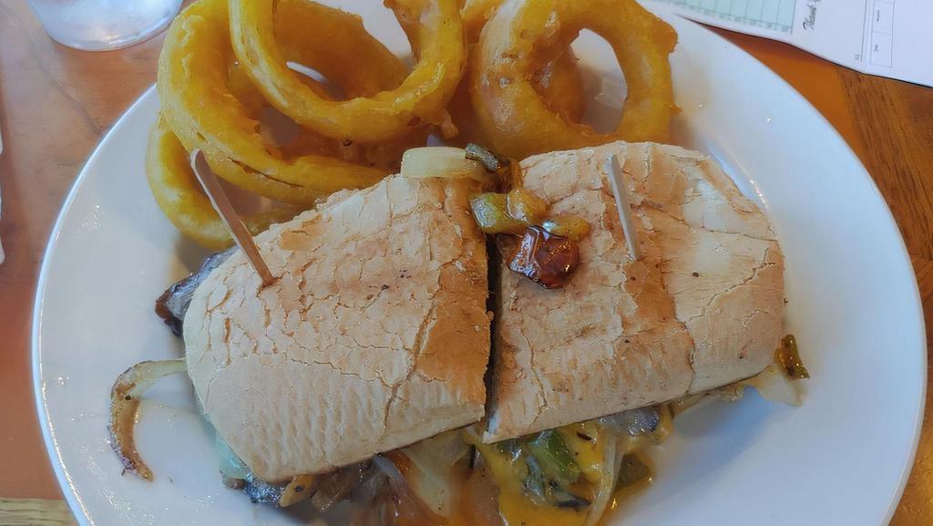 Exclusive · Sliced roasted beef with sautéed onion, peppers, and cheddar on a French roll.

Served raw or undercooked, or contains raw or undercooked ingredients. Consuming raw or undercooked meats, poultry, seafood, shellfish, or eggs may increase your risk of foodborne illness.