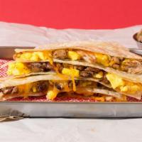 Carnitas Breakfast Quesadilla · Breakfast quesadilla filled with carnitas, eggs, melted cheese, pico de gallo, and served wi...
