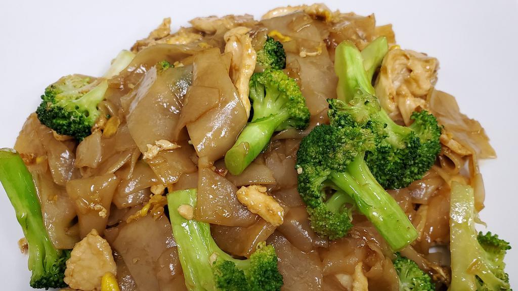 Pad See Iew · Chinese broccoli and carrots stir fried in homemade light brown sauce with a wide rice noodle and egg.