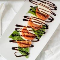 Caprese Salad · Sliced beef steak tomatoes with fresh, hand-made mozzarella, roasted bell peppers and basil,...