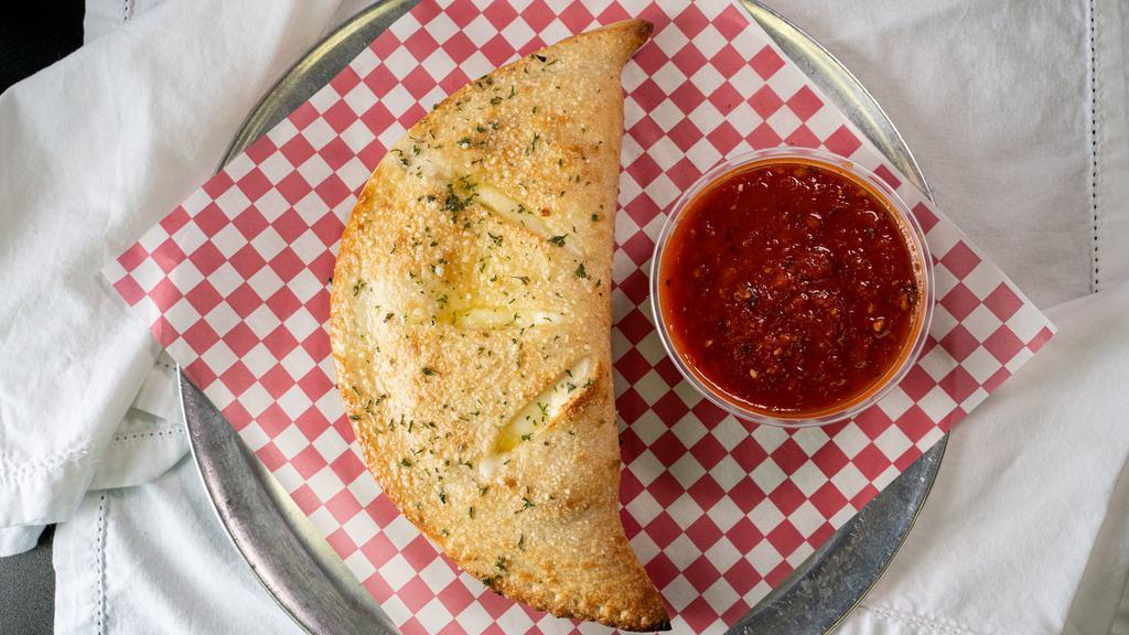 Calzone · Homemade dough stuffed with ricotta, mozzarella, and Parmesan cheese, then baked and served with marinara sauce on the side.