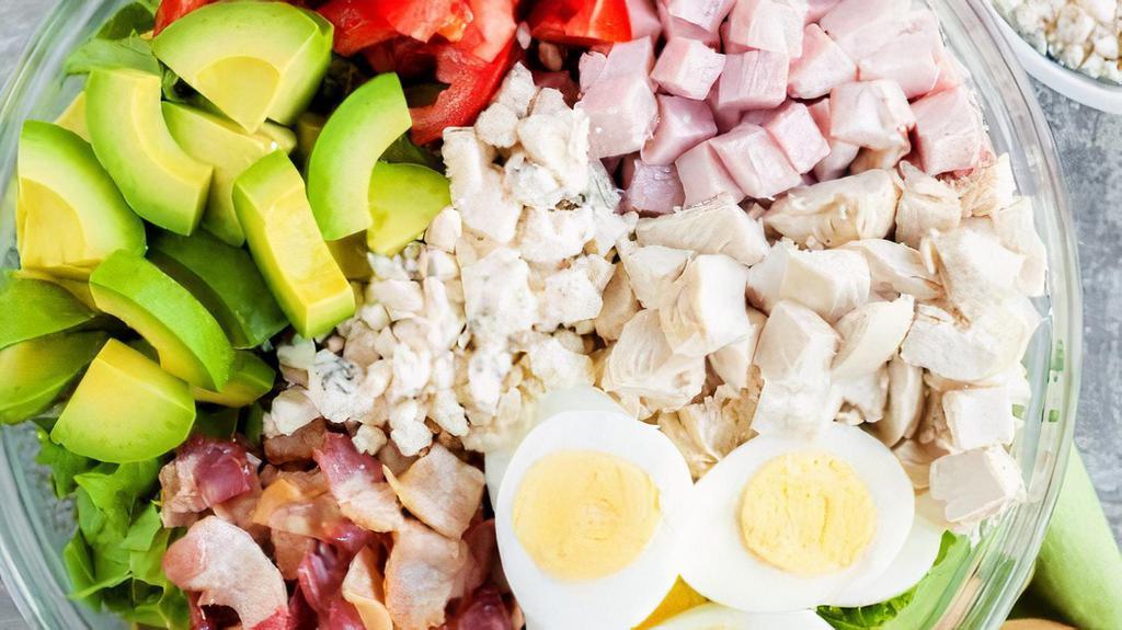 Cobb · Sliced chicken breast on top of mixed greens, tomato with bleu cheese crumbles, hard-boiled egg, bacon and avocado.
