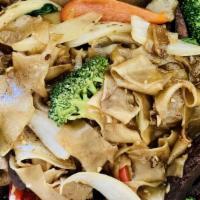 Drunken Noodle · Spicy. Gluten-free. Stir-fried flat rice noodles with garlic, mushrooms, broccoli, sweet oni...