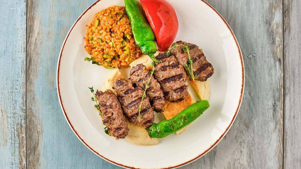 Kafta Kabob Plate · Skewered ground beef and lamb mixed with fresh parsley, onions, garlic and our house spices, grilled to juicy perfection and served on a bed of our aromatic, fluffy rice pilaf. Comes with our house salad and our signature tzatziki sauce.