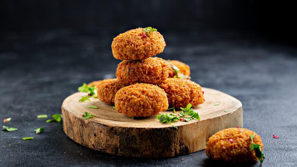 Falafel (3 Pcs) · House-made chickpea and fresh herb fritters, deep-fried until crispy on the outside.