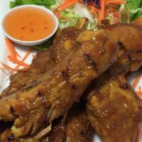55 - Bbq Spare Ribs · Char-broiled pork ribs marinated with house Thai style BBQ sauce served with sweet-sour sauce.