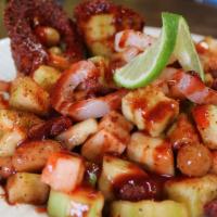 Pepino Loco · Two cucumbers filled with pickle pork skin, peanuts, tamarind candy, chamoy, clamato, hot sa...
