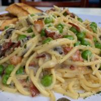 Spaghetti Alla Carbonara · Bacon, Mushrooms, Green Peas, Parmesan Cheese and Marinara Sauce served over Spaghetti Pasta