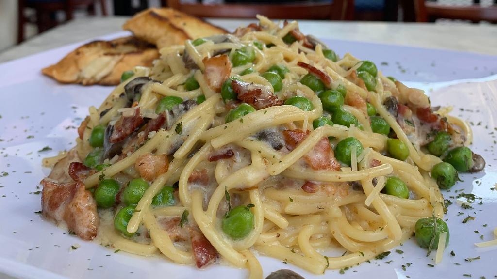 Spaghetti Alla Carbonara · Bacon, Mushrooms, Green Peas, Parmesan Cheese and Marinara Sauce served over Spaghetti Pasta