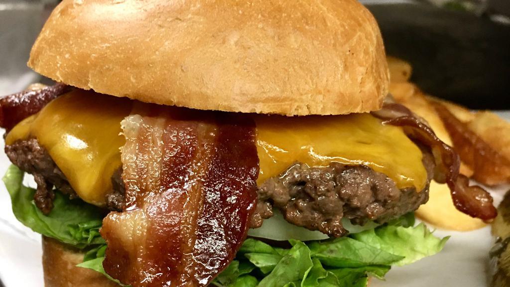 Biergarten Pub Burger · 1/2 lb. patty served on a brioche bun, lettuce, tomatoes, onion, cheese, 2 slices of bacon, and mayonnaise, served with steak cut fries.