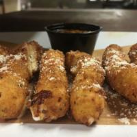 Mozzarella Cheese Sticks · A (6) pack of deep fried mozzarella cheese sticks served with marinara sauce.