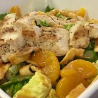 Asian Chicken Salad · Marinated grilled chicken breast over romaine lettuce topped with mandarin oranges, bell pep...