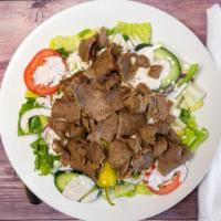 Gyros Salad · Thinly sliced blend of beef and lamb cooked on a vertical rotisserie.