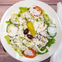 Greek Salad · Romaine lettuce topped with bell peppers, red onions, cucumbers, feta cheese, tomatoes, Gree...