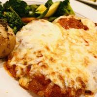 Chicken Parmigiana · Pan fried breast of chicken topped with tomato sauce and melted mozzarella cheese.