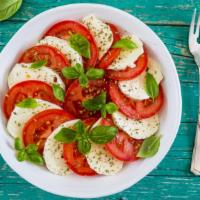 The Caprese Salad · Fresh salad made with mozzarella cheese, sliced tomatoes, basil, and topped with a balsamic ...