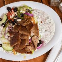 Lamb Plate · Thin marinated slices of lamb over basmati rice, with a side of hummus, side salad, tzatziki...