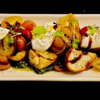 Heirloom Tomatoes And Burrata · Grilled sourdough croutons, extra virgin olive oil, balsamic vinegar, basil pesto.  470 cal.