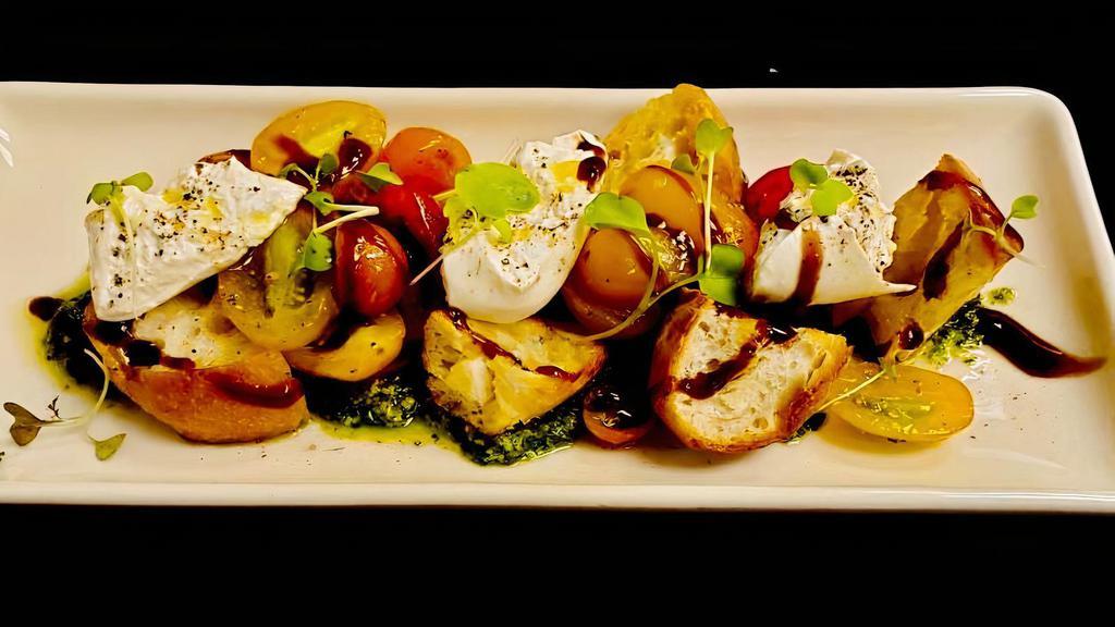 Heirloom Tomatoes And Burrata · Grilled sourdough croutons, extra virgin olive oil, basil pesto.  470 cal.