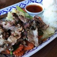 Kao- Moo-Yang (Bar-B-Q Pork) · Charcoal broiled pork marinated in thai spices and mixed herbs, served over sauteed cabbage,...
