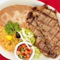 Carne Asada · Two thin-sliced grilled New York choice served with a side of our homemade guacamole.