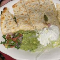Quesadilla · Corn or flour tortilla with melted Monterey Jack cheese with sour cream and guacamole on the...