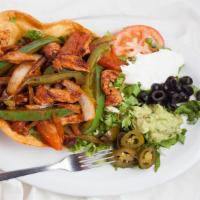 Fajita Taco Salad · Marinated beef or chicken or both, grilled with bell peppers, onions, and tomatoes, served i...