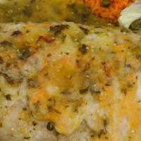 Chile Verde Burrito · Pork chile verde, rice, and beans rolled in a large flour tortilla topped with green sauce, ...