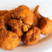 Buffalo Cauliflower · Cauliflower bites, breaded, and fried, tossed with hot wing sauce, served with blue cheese d...