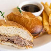 French Dip Sandwich · Roast beef and Swiss cheese on a French roll with au jus and fries.