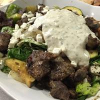 Beef Fatoush Salad · Fatoush salad topped with charbroiled beef grilled veggies feta cheese and tzatziki sauce