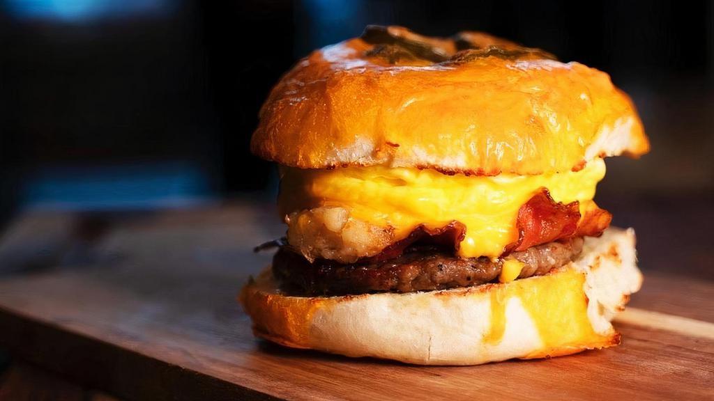 The Ultimate Beggelwich · A Toasted, Buttered Bagel with Eggs, Sausage, Bacon, Hash Browns & American Cheese