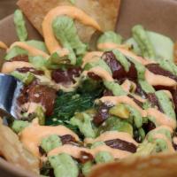 Ahi Poke Bowl · Fresh Raw Ahi marinated in soy sauce,
ginger, crushed red pepper, and sesame
oil, topped wit...