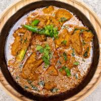 Goat Karahi · Cooked fresh goat in thicker curry is sizzling and full of flavor.