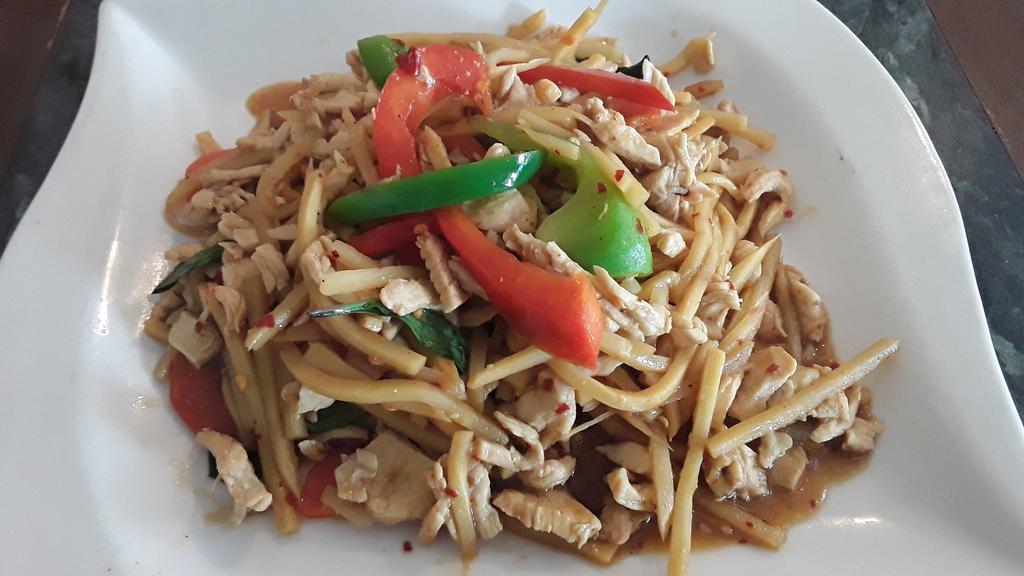 Basil Chicken · Chicken breast sautéed with fresh chili, garlic, bamboo shoots, bell pepper and Thai basil leaves.