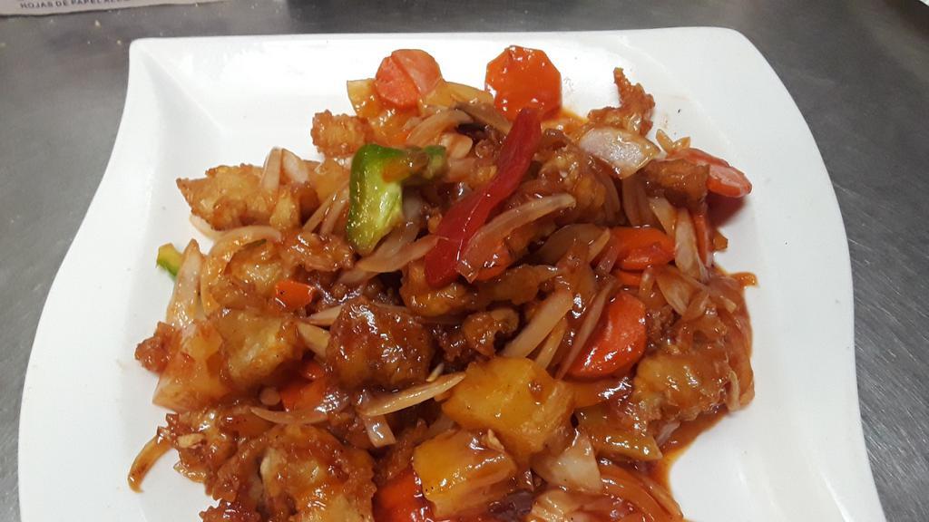 Sweet & Sour Chicken · Chicken breast sautéed with pineapple, onion, green onions, bell pepper and tomatoes in sweet and sour sauce.