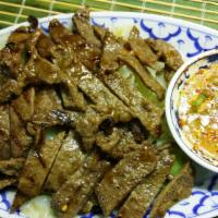 Tiger Cry Beef · Spicy. Marinated sirloin steak with Thai herbs and broiled to your taste; served with spicy ...