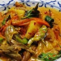 Red Duck Curry · Spicy. Slices of boneless roasted duck simmered in red curry with coconut milk, pineapple, t...